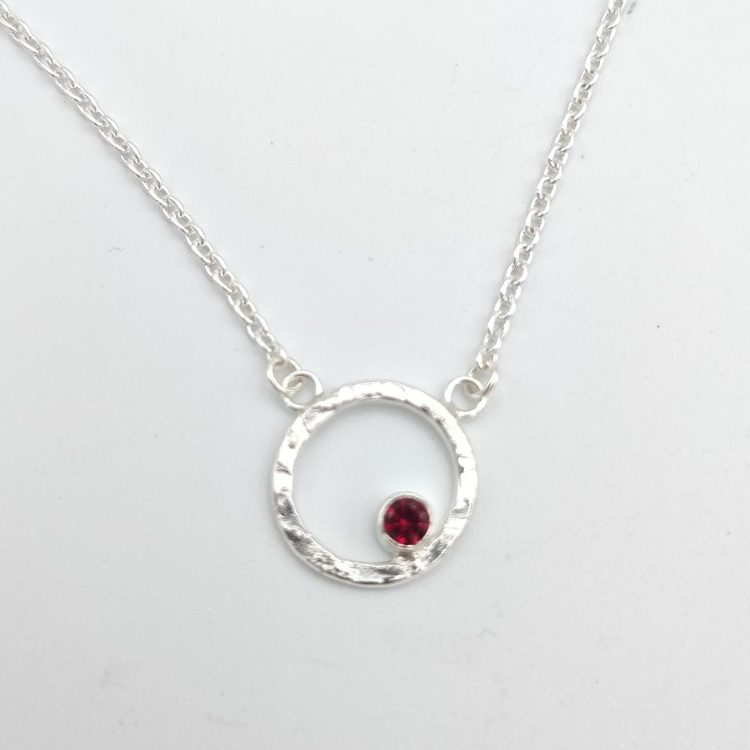 Garnet birthstone in hammered sterling silver circle pendant necklace