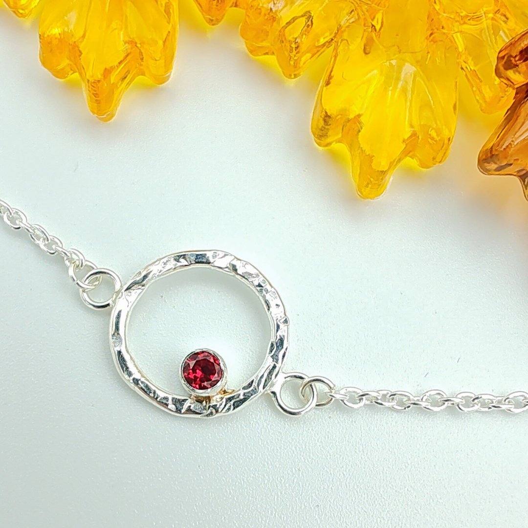 Sterling silver hammered halo and garnet bracelet