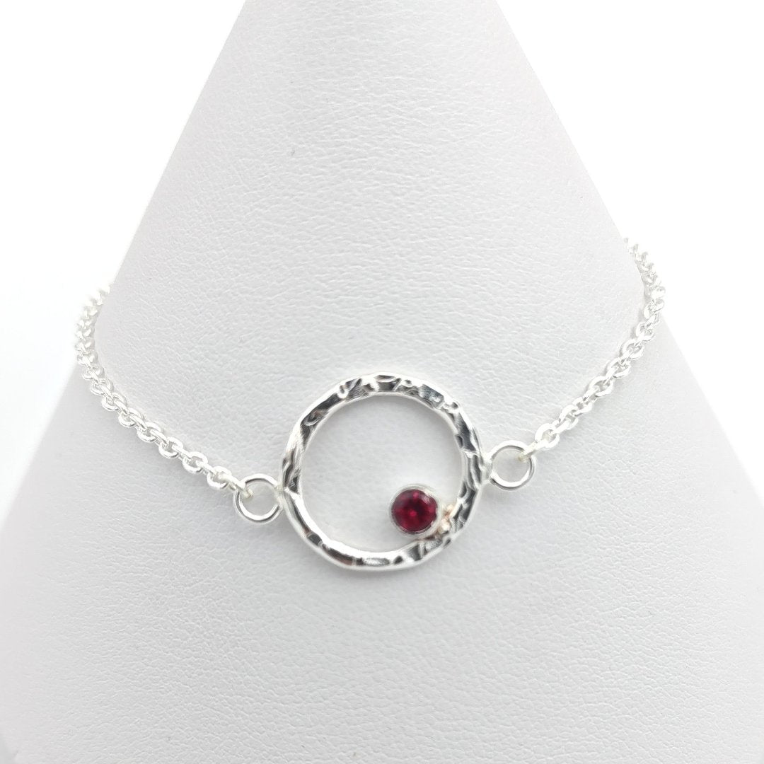 Sterling silver hammered halo and garnet bracelet