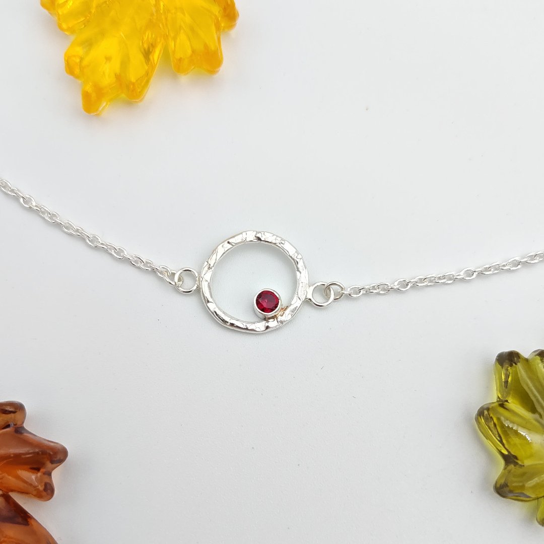 Sterling silver hammered halo and garnet bracelet