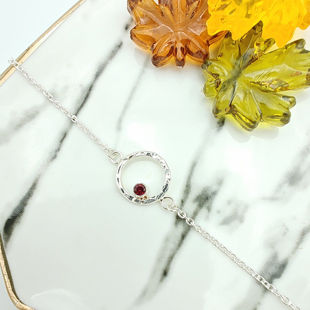 Sterling silver hammered halo and garnet bracelet