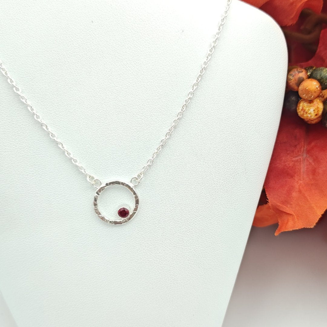 Garnet birthstone in hammered sterling silver circle pendant necklace