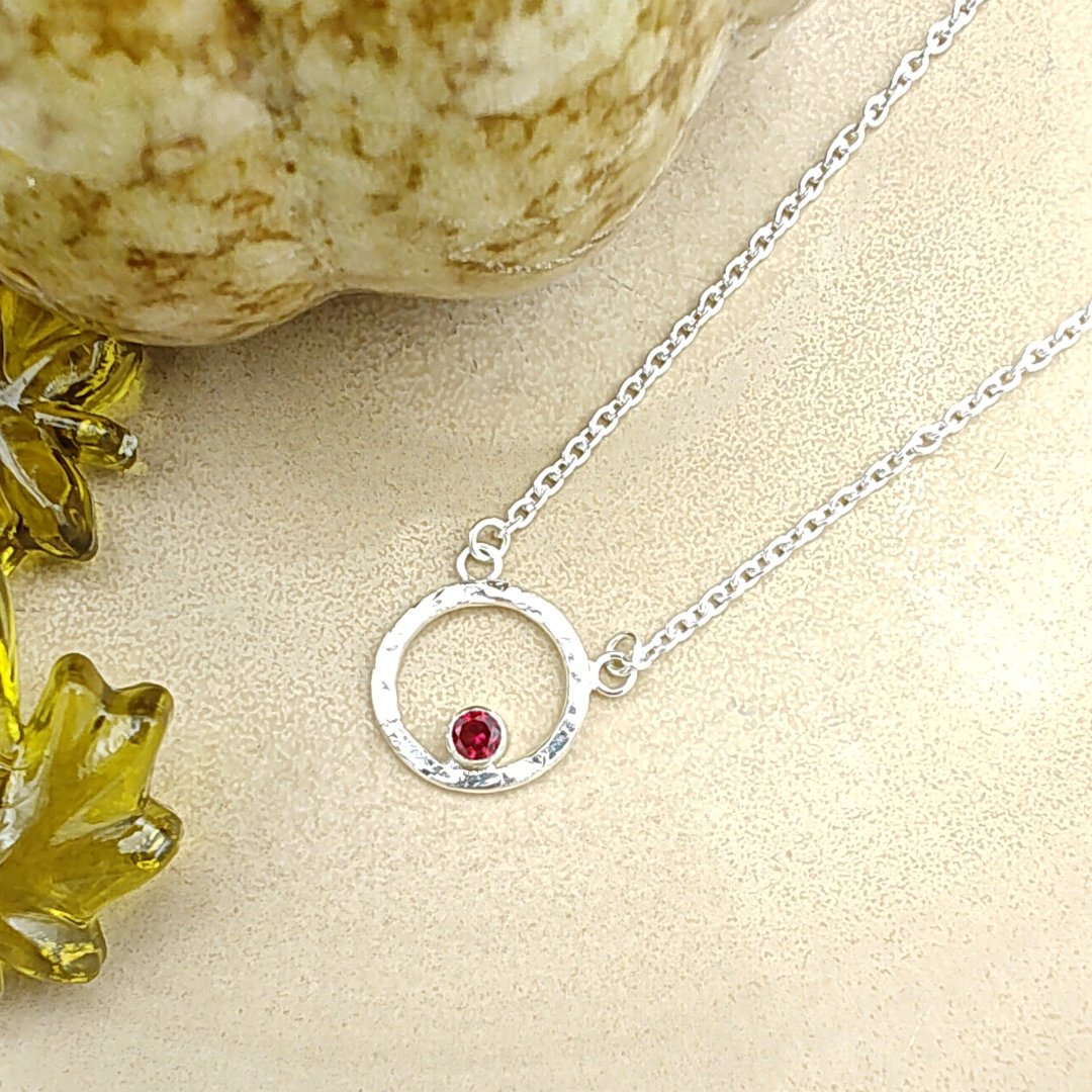 Garnet birthstone in hammered sterling silver circle pendant necklace