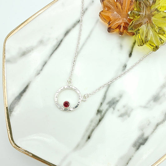 Garnet birthstone in hammered sterling silver circle pendant necklace